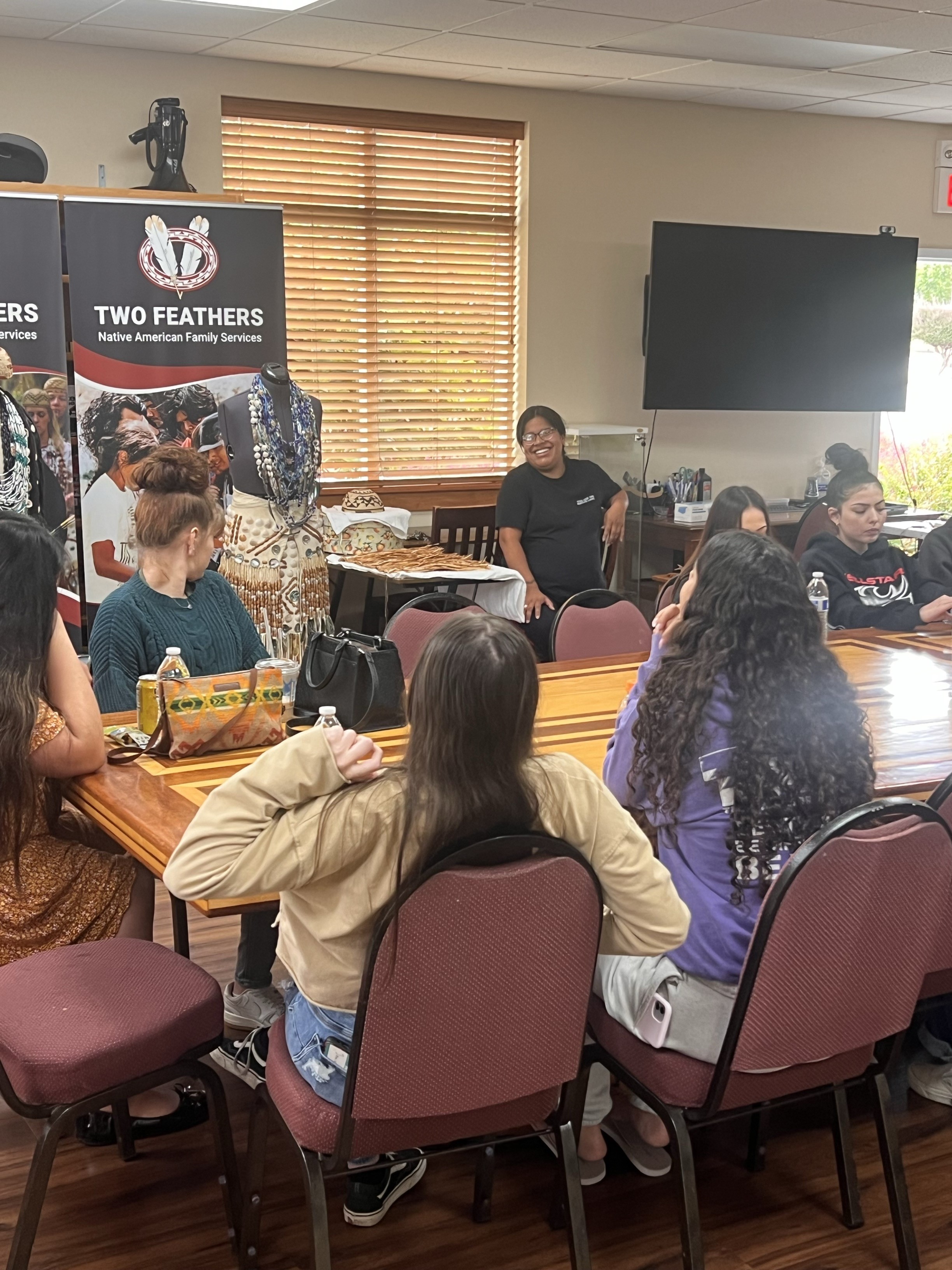 Photo of Native youth in discussion around a table